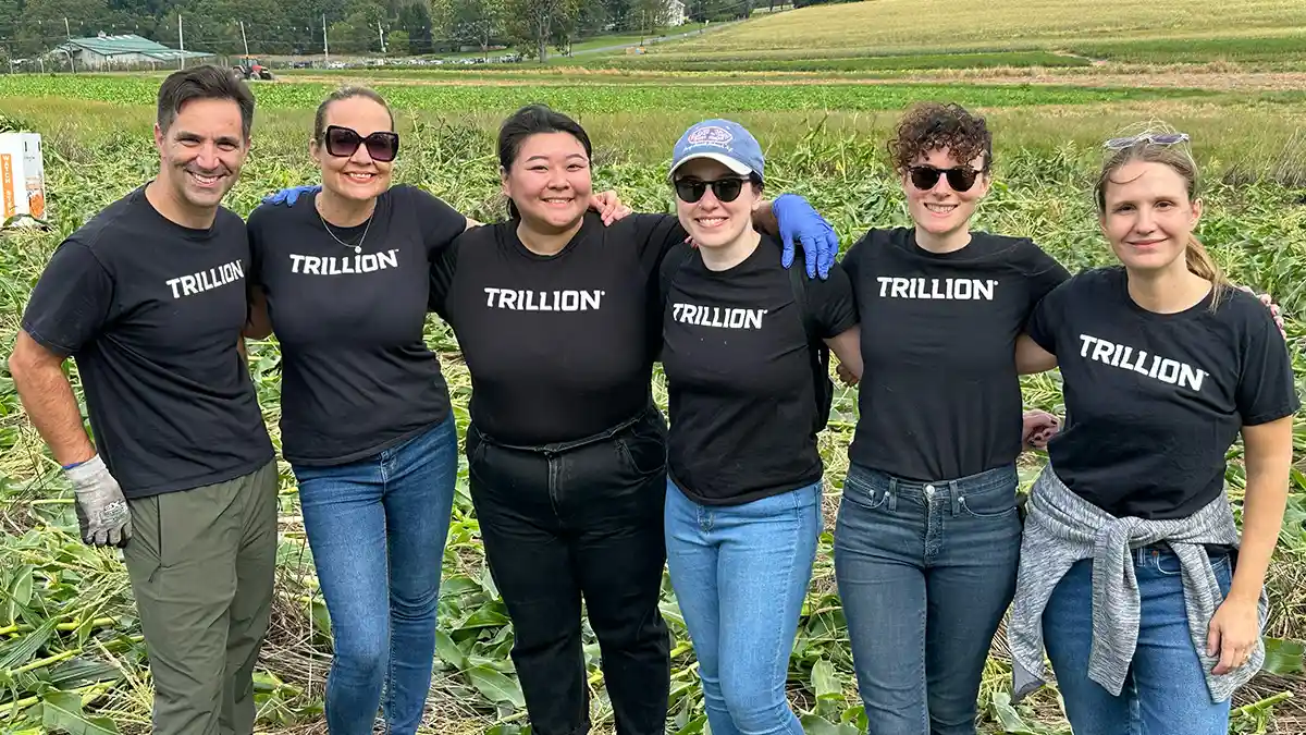 A group photo of Trillionaires donning Trillion branded t-shirts at a team outing.