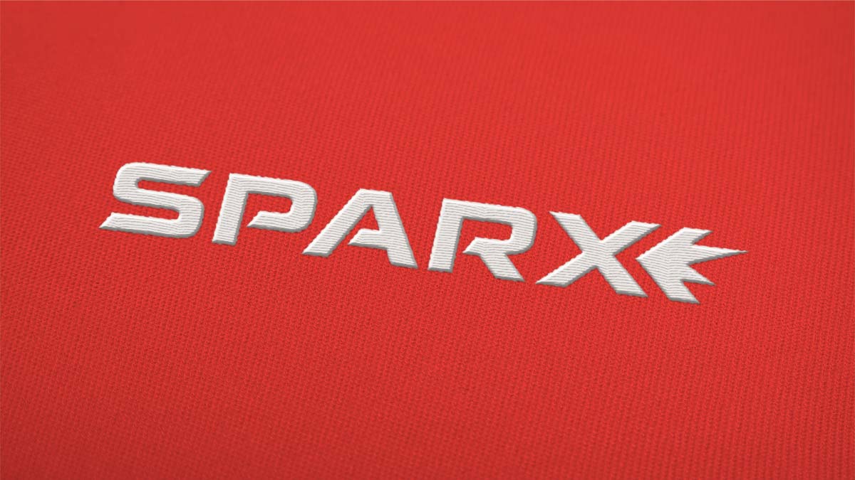 Sparx logo, designed by Trillion, embroidered on red fabric