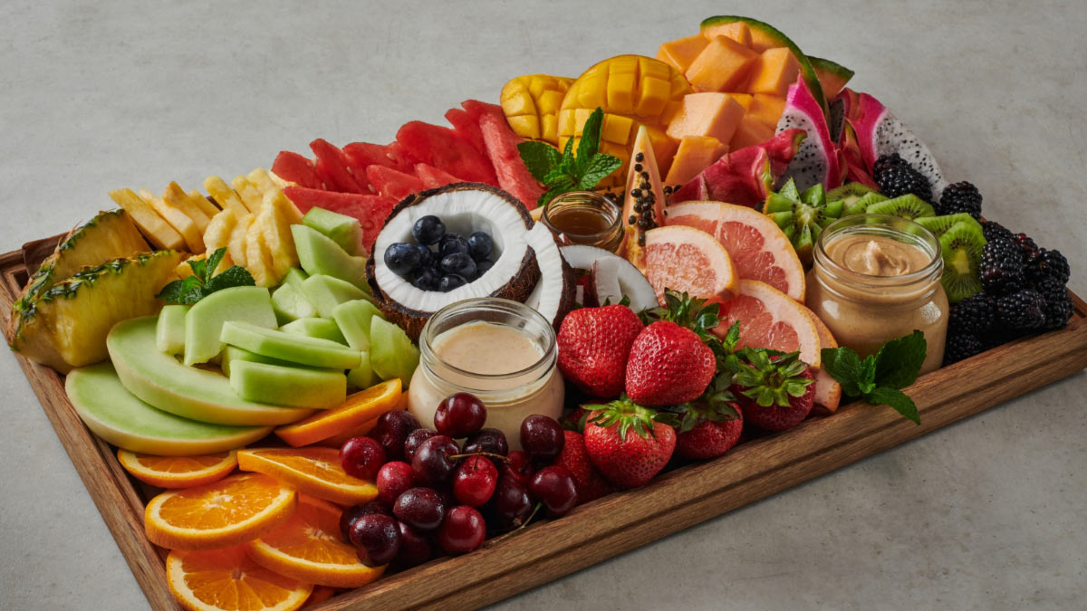 Fruit tray on wooden platter at Mercedes-Benz Stadium. Photo by Angie Webb, and food styling by Tami Hardeman.