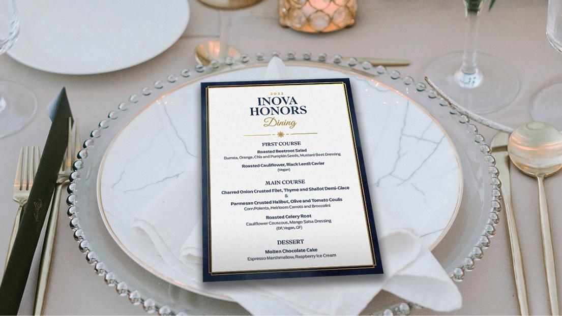Gala event branding for the dinner menu shown on an elegant table place setting. 