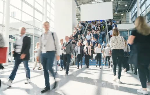 A crowded convention center with lots of people