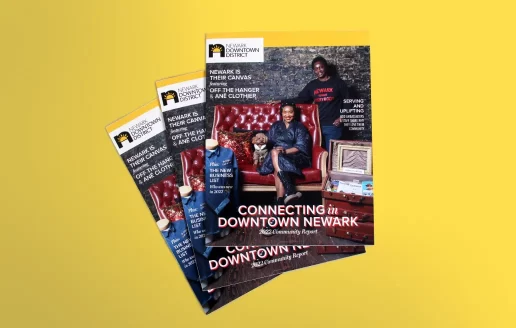 A stack of annual impact report cover designs for Newark Downtown District on a yellow background.