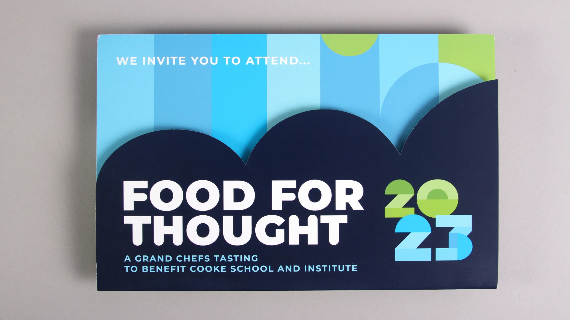 The Food for Thought 2023 gala invitation design with die cut cover.