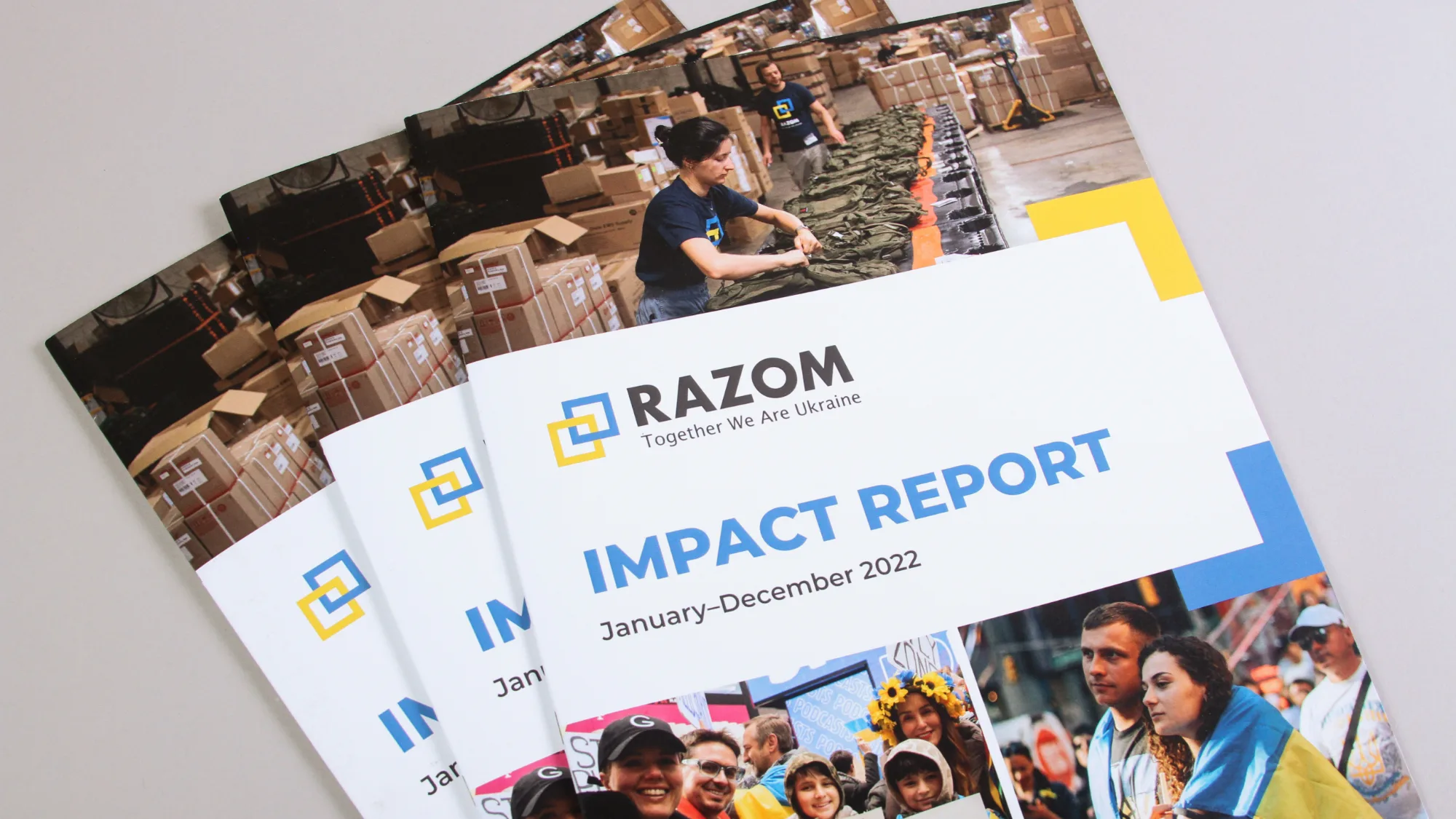 Stack of Razom Impact Report booklets.