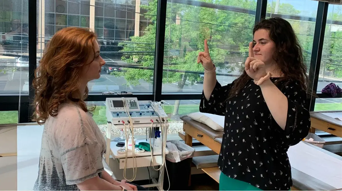 A physical therapist doing a test with a patient. 