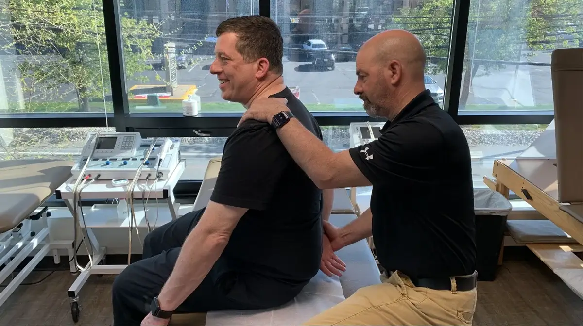 A physical therapist performing a massage on his client.