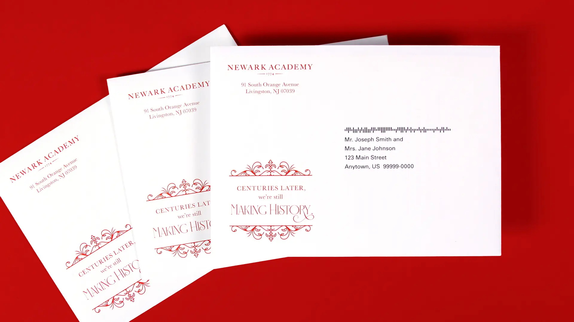 Outer envelopes with a red flourishing design around the campaign name.