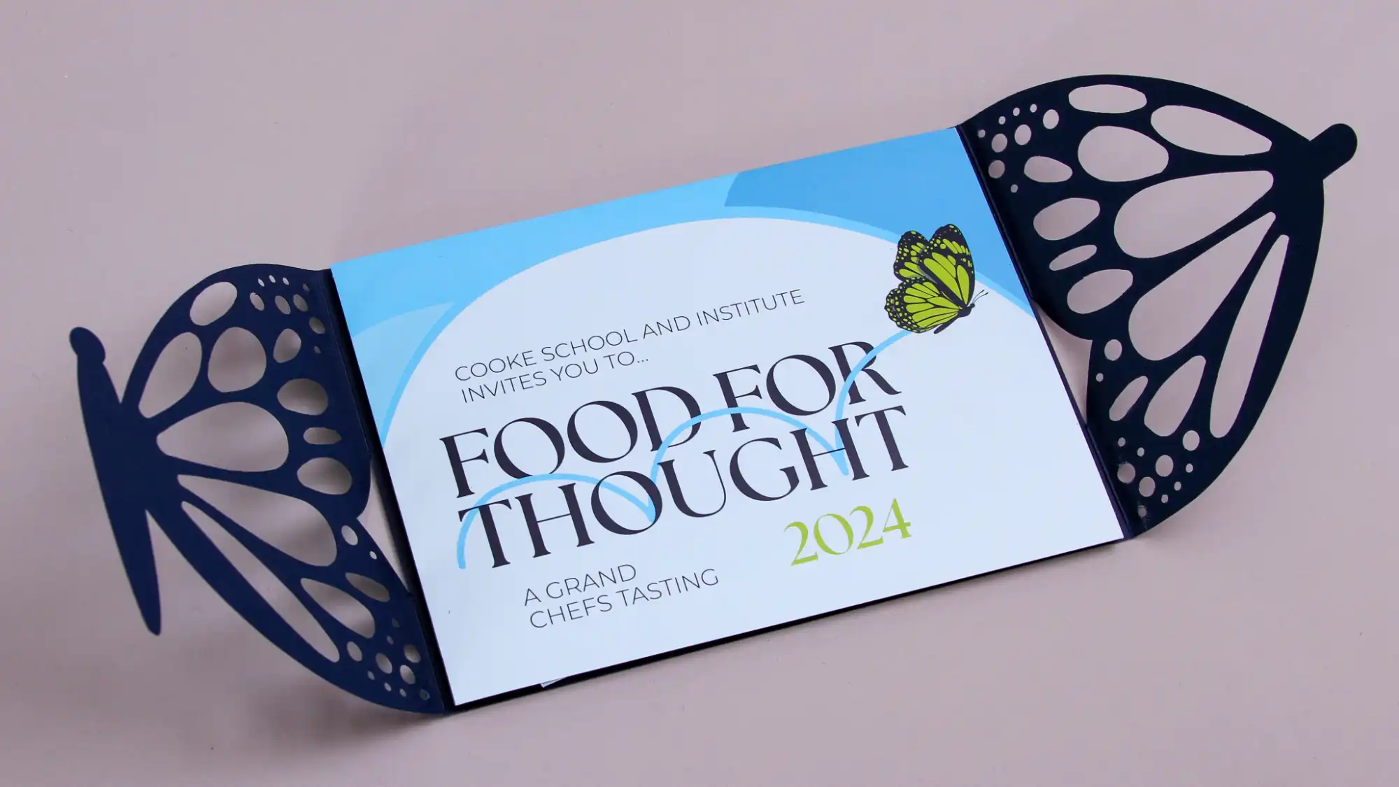 The Food for Thought 2024 gala invitation on a grey background.