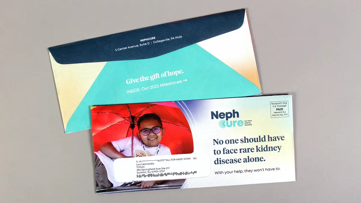 The envelope front and back for the Nephcure end of year appeal mailing, featuring a large photo and a gradient background.