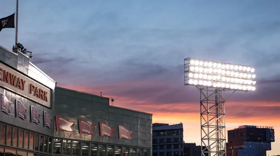 A photo of Fenway Park with an evening sky background,