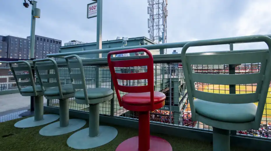 A photo of green and red seating at Fenway Park.