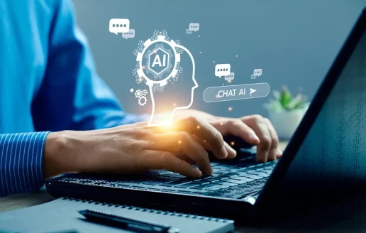 A photo of a person using AI search on their laptop.