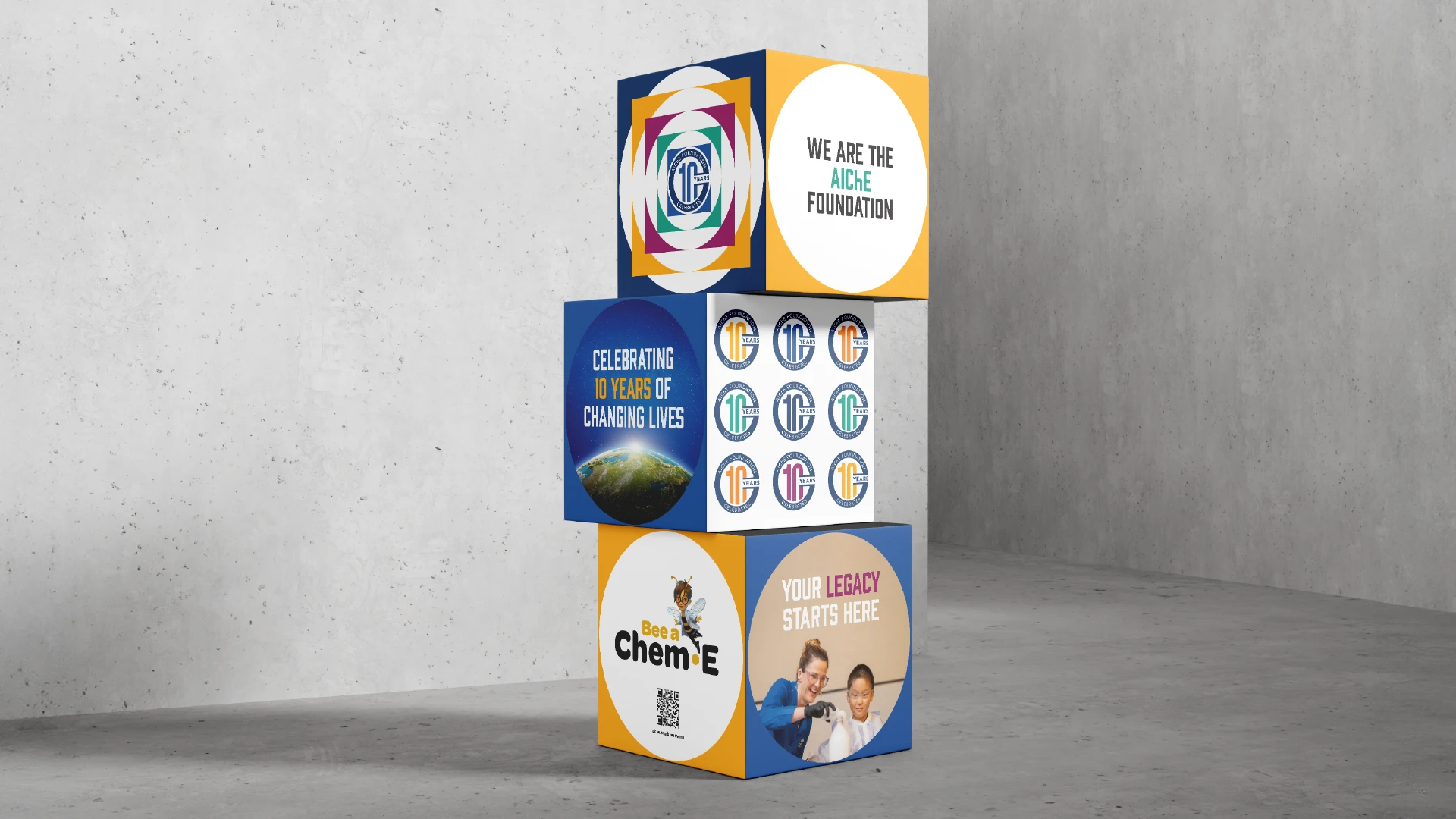 Large trade show cubes with graphics and anniversary branding applied to them.