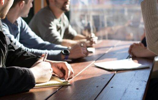 A small team reviewing marketing plans and notes together at a table